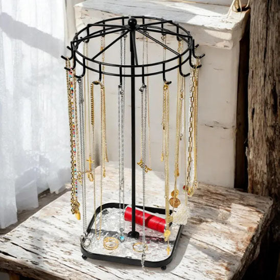 Bijoux-rangement-support-rotatif-noir-posé-sur-une-table-ancienne