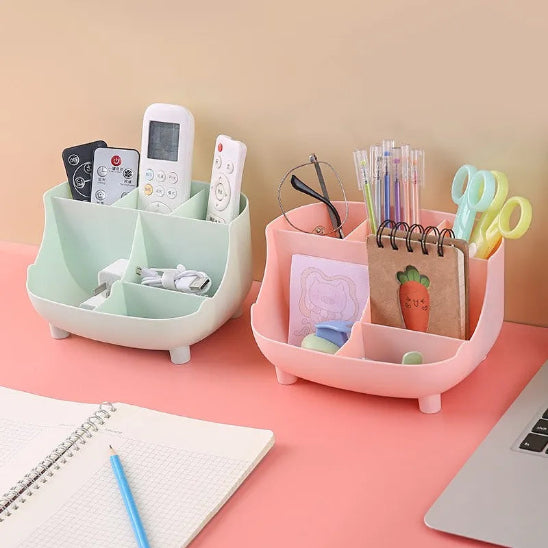 Organisateur de bureau ProEspace rose et vert posés sur bureau rose