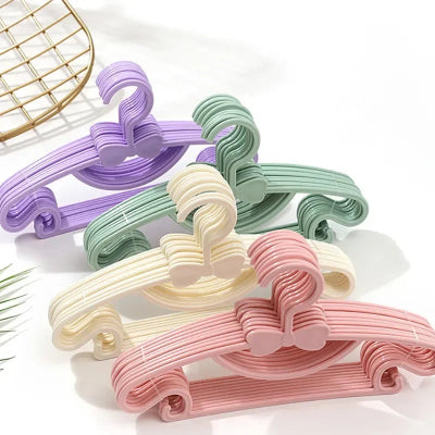 Cintre enfant plusieurs couleurs posés sur table