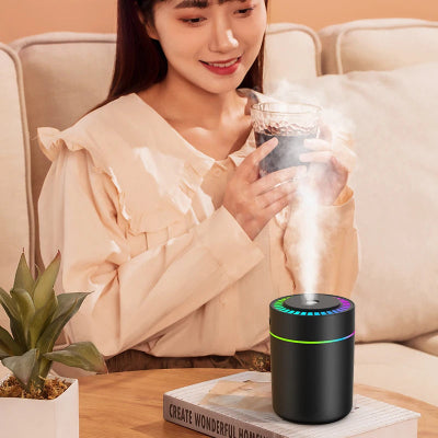 Humidificateur d'air chambre noir pos sur table basse en face une utilisatrice