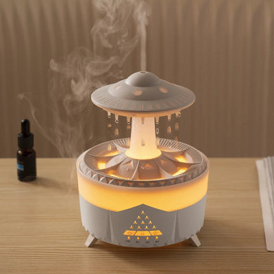 Humidificateur d air  OVNI blanc posé sur bureau avec flacon huile 