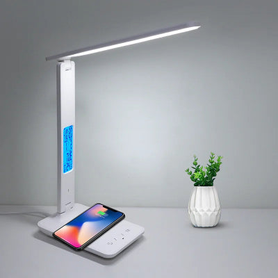 Lampe de bureau SmartProtect blanc sur bureau côté pot plantes