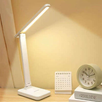 Lampe bureau une branche allumée sur bureau côté horloge