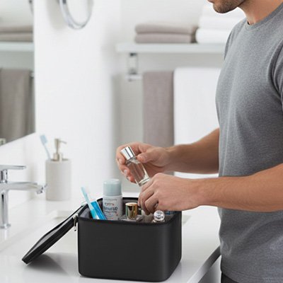 Trousse de toilette homme noir ouverte présence un jeune homme